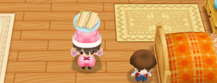 The farmer stands next to Yu while holding a Sandwich.